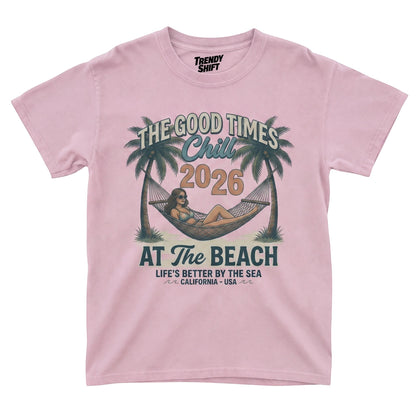  light pink graphic t-shirt featuring a retro beach hammock scene with palm trees and summer text.