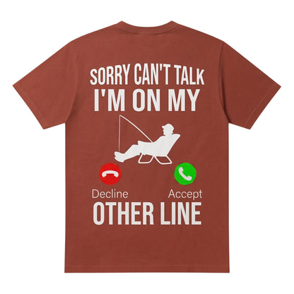  rust-colored 100% cotton t-shirt featuring a fishing-themed Sorry can't talk I'm on my other line graphic