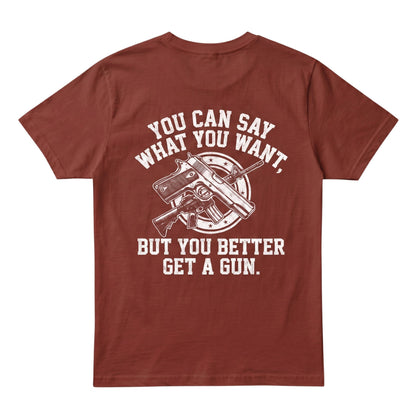  rust-colored cotton t-shirt featuring a white graphic print of firearms and bold text on the back.